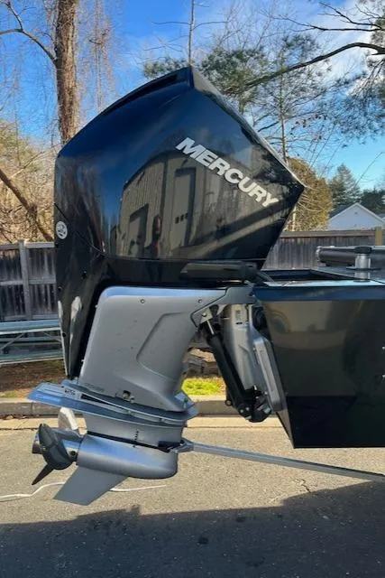 Slide: The Image of 2024 Regency 230 LE3 boat with a Mercury outboard motor. - 5