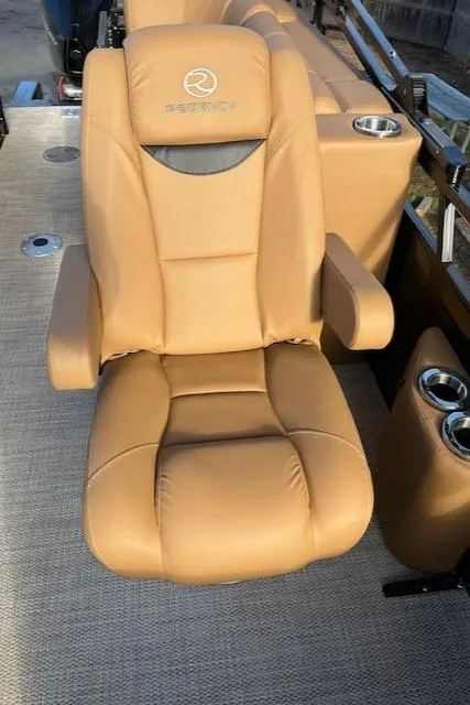 Slide: The Image of Luxurious tan captain's chair on 2024 Regency 230 LE3 boat. - 8