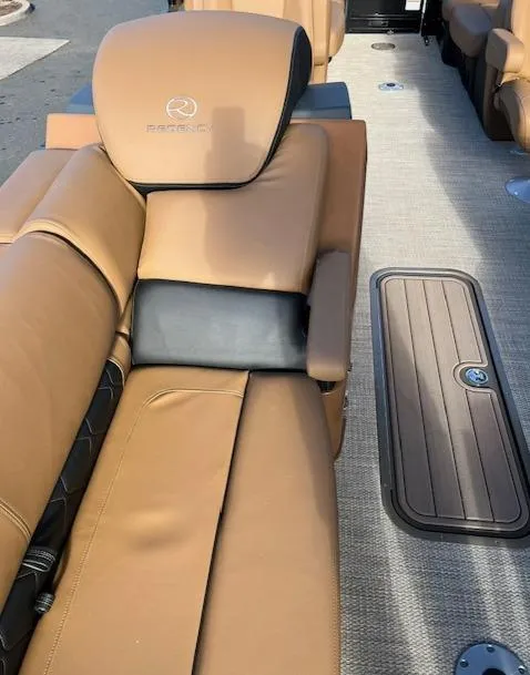 Slide: The Image of 2024 Regency 230 LE3 boat with tan leather seating and storage compartment. - 9