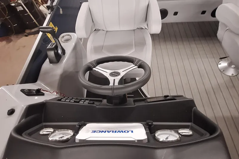 Slide: The Image of 2024 Bentley Pontoons Legacy 243 Swingback helm with steering wheel and Lowrance display. - 11