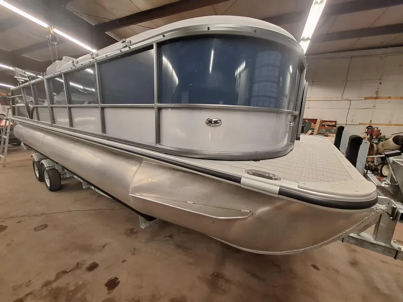 Slide: The Image of 2024 Bentley Pontoons Legacy 243 Swingback pontoon boat in a warehouse. - 2