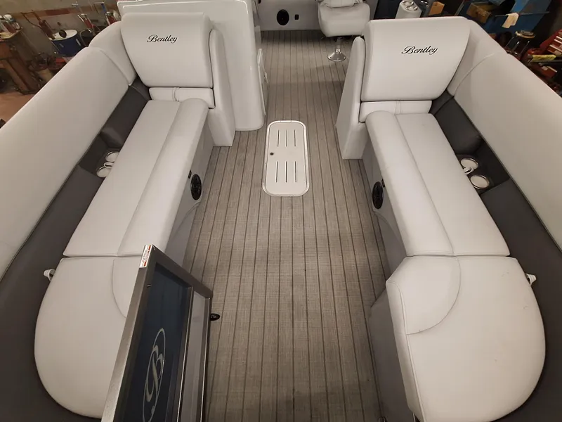 Slide: The Image of 2024 Bentley Pontoons Legacy 243 Swingback interior with white seating and gray flooring. - 4