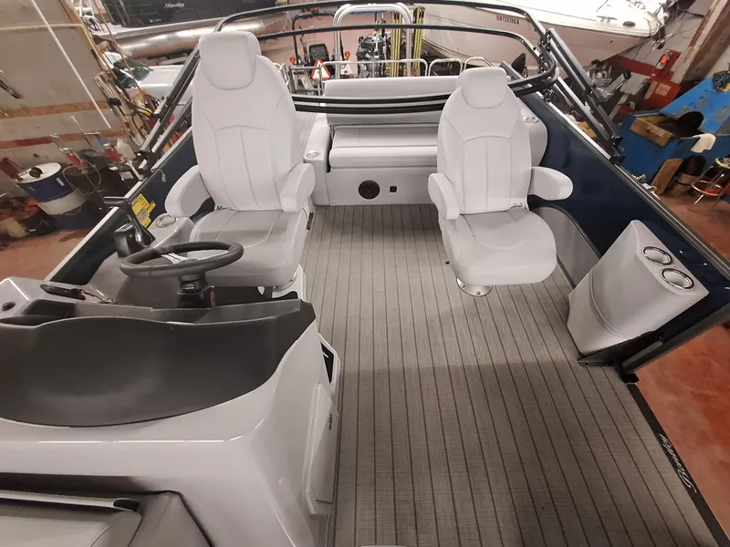 Slide: The Image of 2024 Bentley Pontoons Legacy 243 Swingback interior with white seats and steering console. - 5