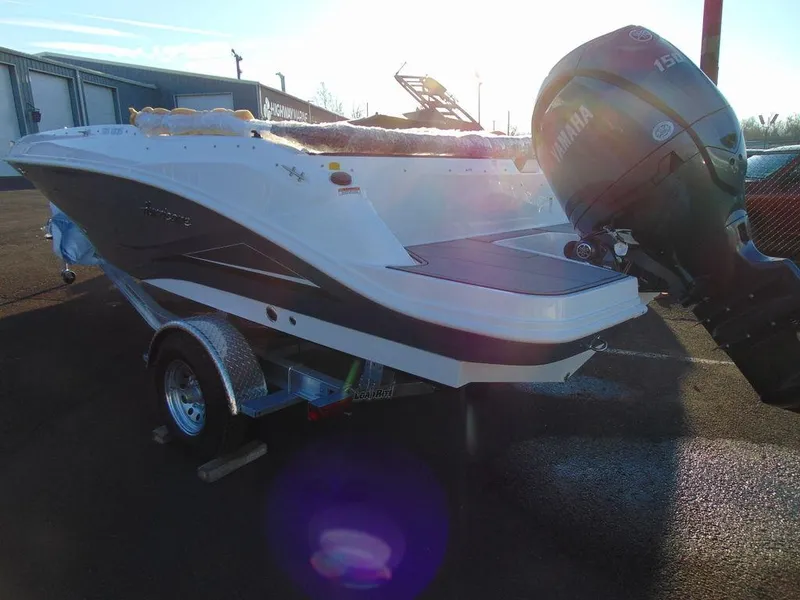Slide: The Image of 2024 Hurricane SunDeck Sport 205 OB boat with Yamaha outboard motor on trailer. - 3