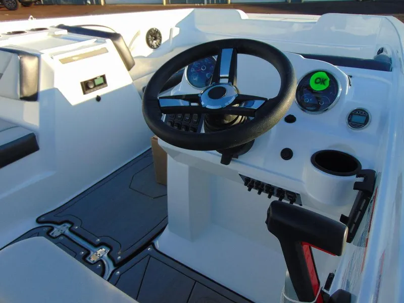 Slide: The Image of 2024 Hurricane SunDeck Sport 205 OB boat cockpit with steering wheel and control panel. - 7