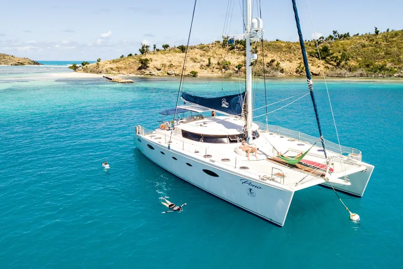 The Image of Luxury 2005 Fountaine Pajot FP Eleuthera 60 catamaran anchored in turquoise waters. - 1