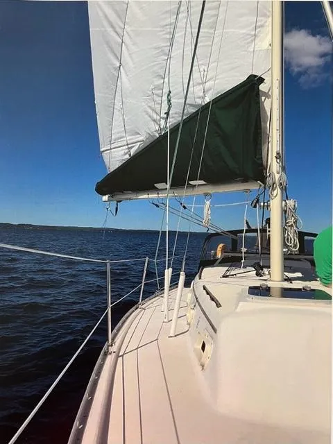 Slide: The Image of 1983 Irwin Citation 34 sailboat on open water under clear blue sky. - 10