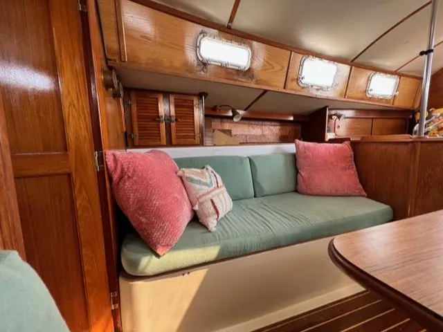 Slide: The Image of 1983 Irwin Citation 34 sailboat interior with wooden cabinetry and cushioned seating. - 7