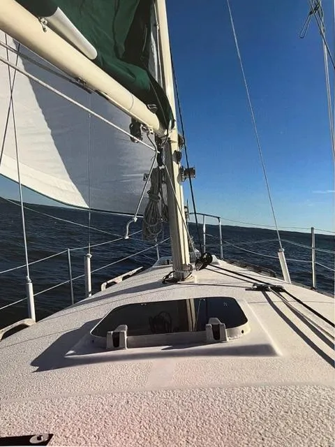 Slide: The Image of 1983 Irwin Citation 34 sailboat on open water with clear blue sky. - 8