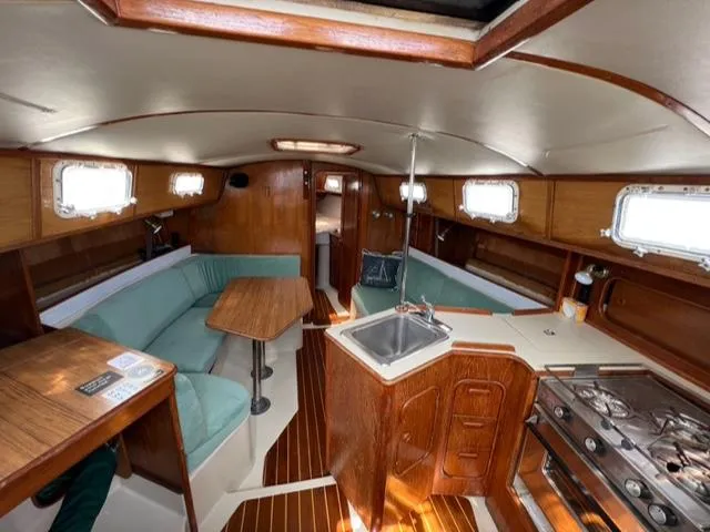Slide: The Image of 1983 Irwin Citation 34 sailboat interior with kitchen, dining area, and wood finishes. - 9