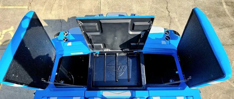 Slide: The Image of 2024 Malibu 23 MXZ boat storage compartments open, showcasing spacious interior. - 11
