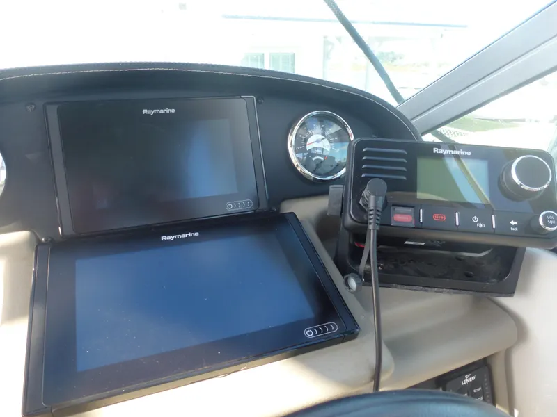 Slide: The Image of 2019 Crownline 264 CR boat dashboard with Raymarine navigation screens and controls. - 12