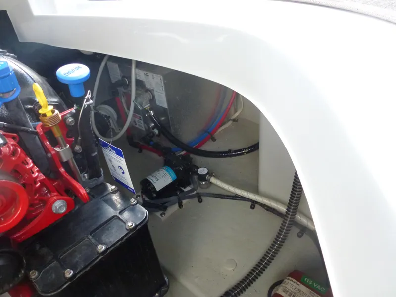 Slide: The Image of 2019 Crownline 264 CR engine compartment with visible wiring and components. - 19