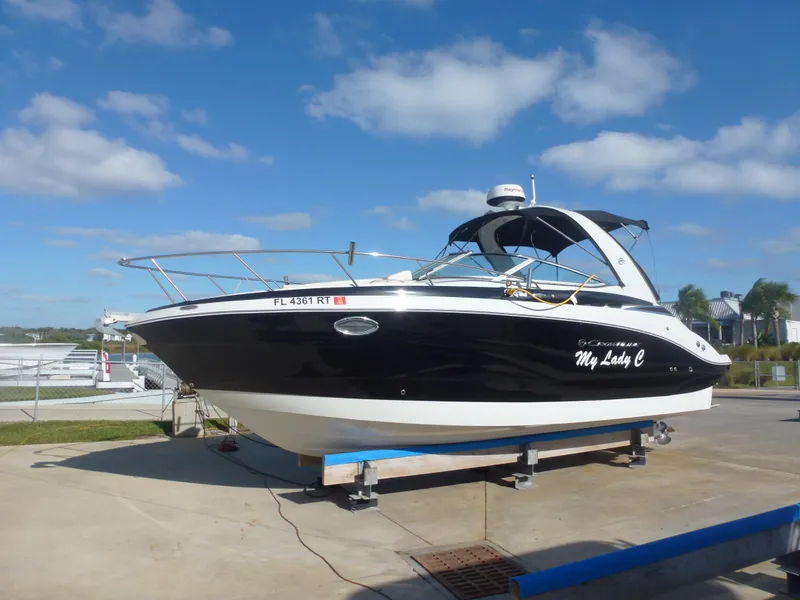 Slide: The Image of 2019 Crownline 264 CR boat on a trailer under a blue sky. - 2