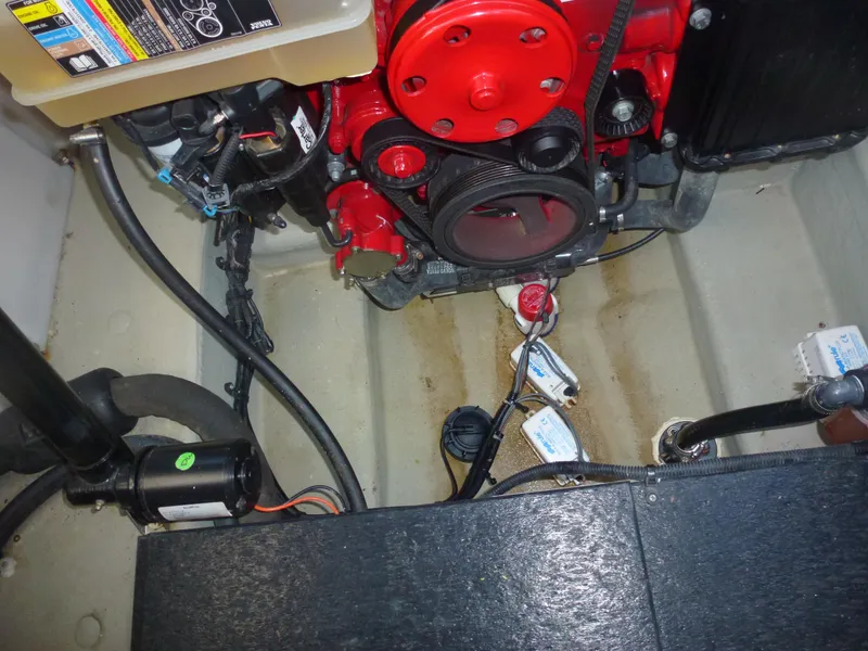 Slide: The Image of 2019 Crownline 264 CR engine compartment with red engine components and wiring. - 20