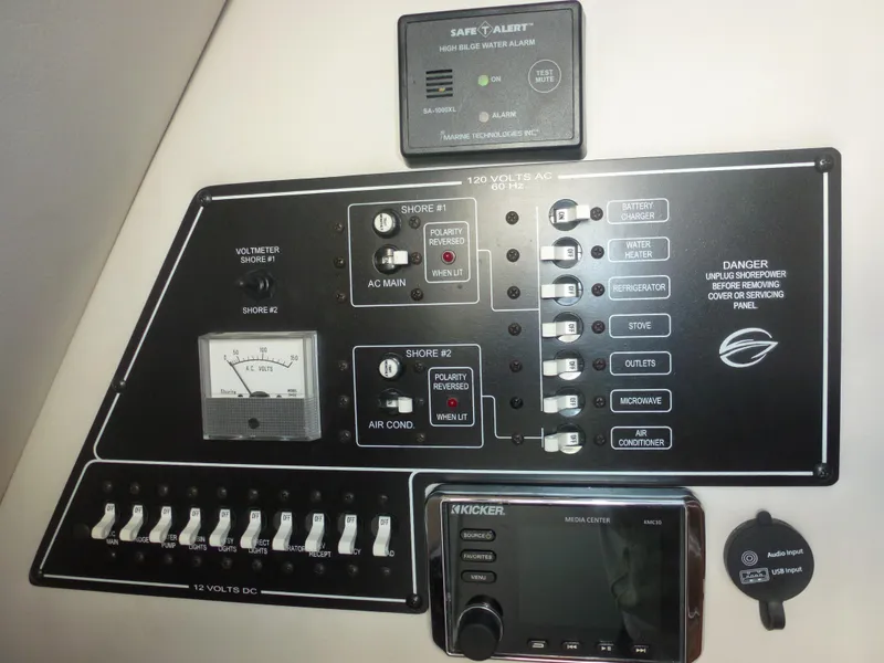 Slide: The Image of Control panel of a 2019 Crownline 264 CR boat with various switches and gauges. - 25
