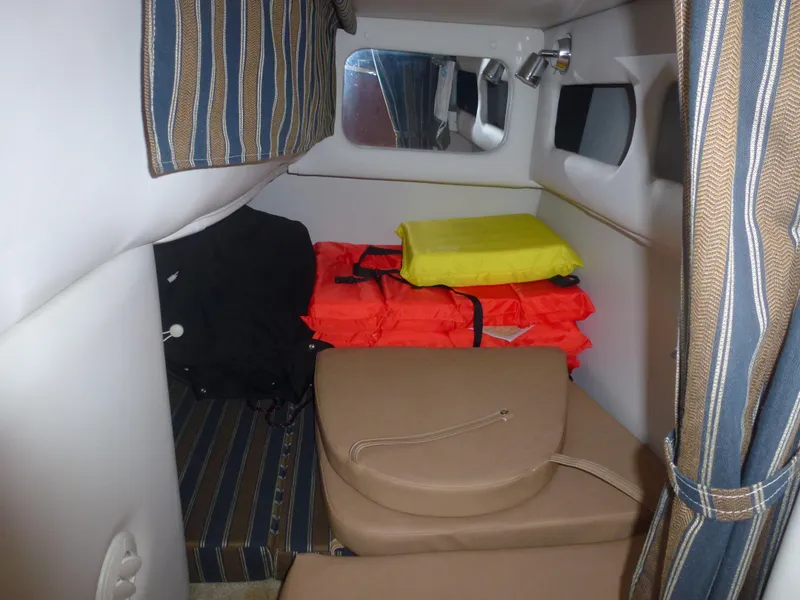 Slide: The Image of 2019 Crownline 264 CR cabin interior with life jackets and cushions. - 27