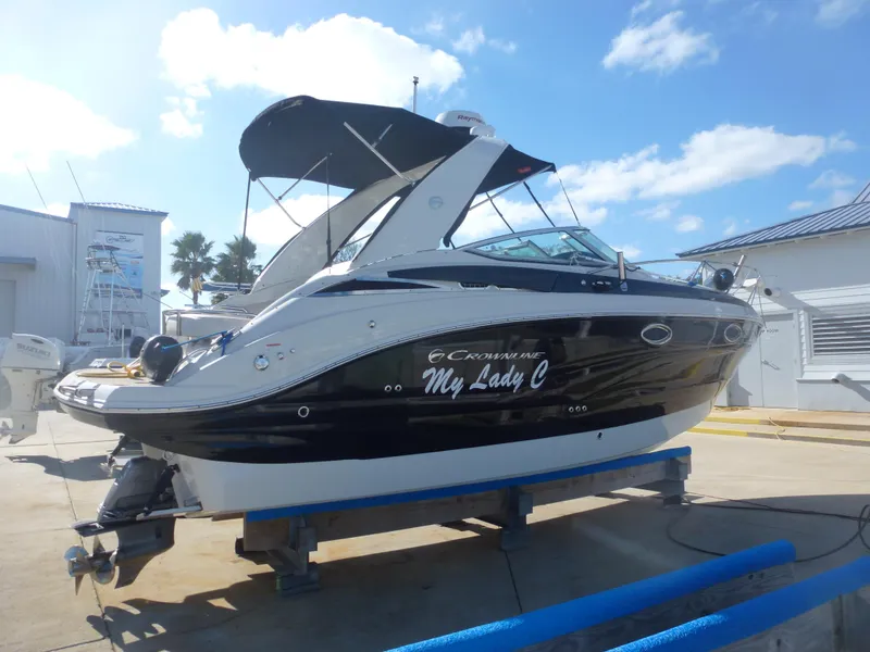 Slide: The Image of 2019 Crownline 264 CR boat on a trailer, black and white exterior, named My Lady C. - 4