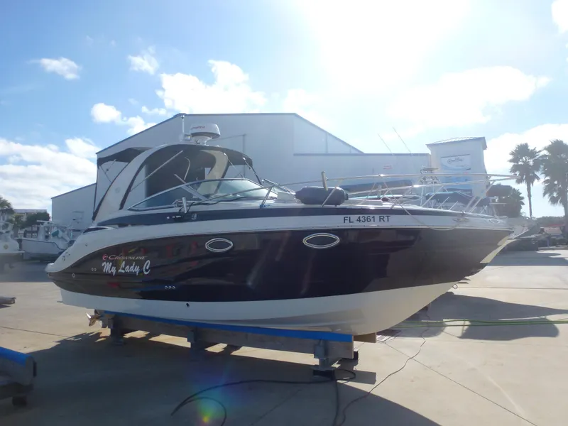 Slide: The Image of 2019 Crownline 264 CR boat on a trailer in a marina. - 5