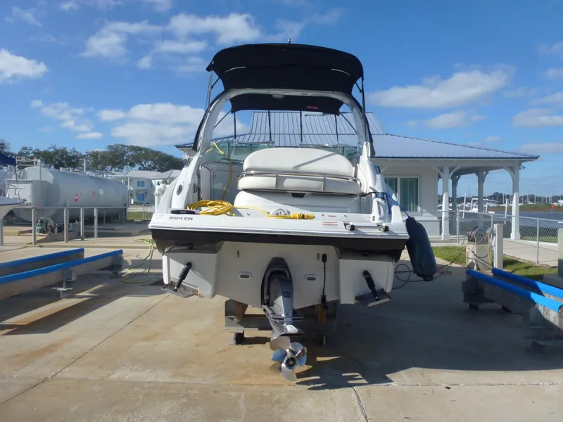 Slide: The Image of 2019 Crownline 264 CR boat on a trailer at a marina. - 6