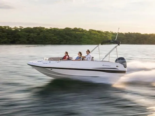 Slide: The Image of 2024 Hurricane SunDeck Sport 201 OB cruising on a serene lake. - 1