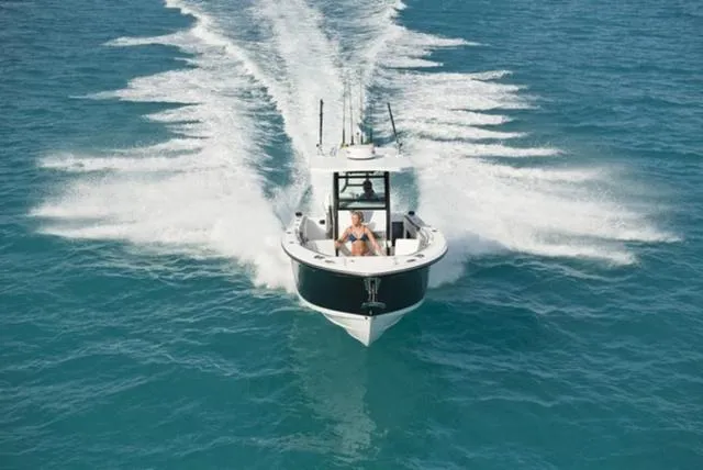 Slide: The Image of 2024 Blackfin 272CC boat cruising on open water, creating a dynamic wake. - 14
