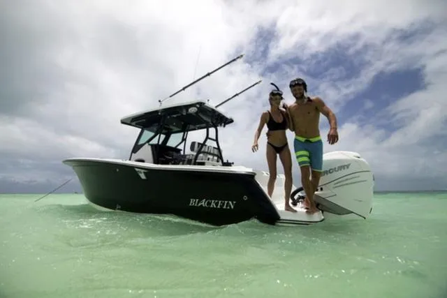 Slide: The Image of 2024 Blackfin 272CC boat with two people snorkeling in clear turquoise water. - 3