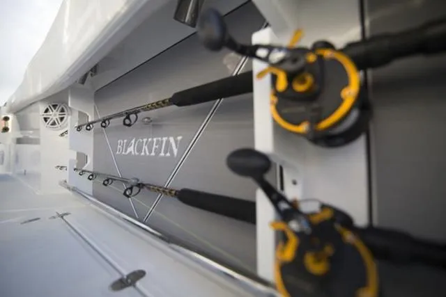 Slide: The Image of 2024 Blackfin 272CC fishing rods storage on sleek boat interior. - 4