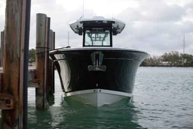 Slide: The Image of 2024 Blackfin 272CC boat docked on calm water. - 9