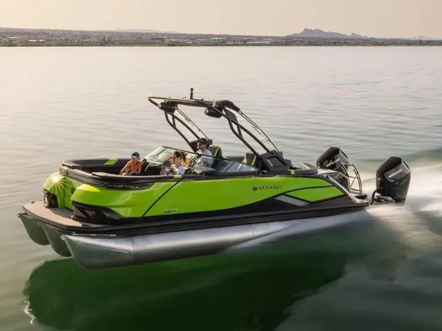 Slide: The Image of 2024 Godfrey Pontoons XP 2700 W Twin cruising on a calm lake. - 1