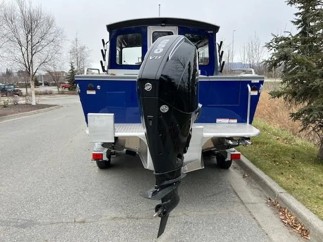 Slide: The Image of 2023 Spartan 220 Maximus Pro boat with powerful V8 engine, parked on a road. - 11