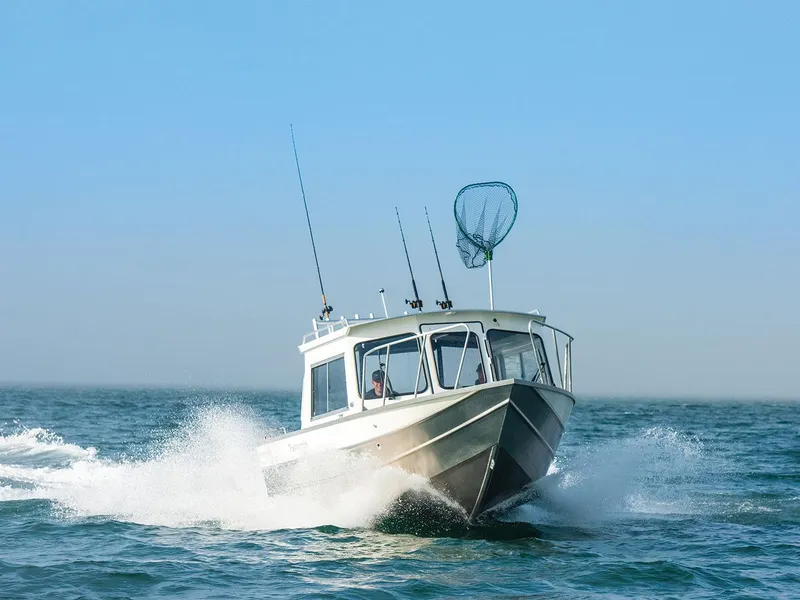 Slide: The Image of 2023 Spartan 220 Maximus Pro boat cruising on open water. - 21