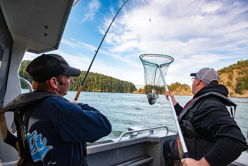 Slide: The Image of Two men fishing on a 2023 Spartan 220 Maximus Pro boat. - 28