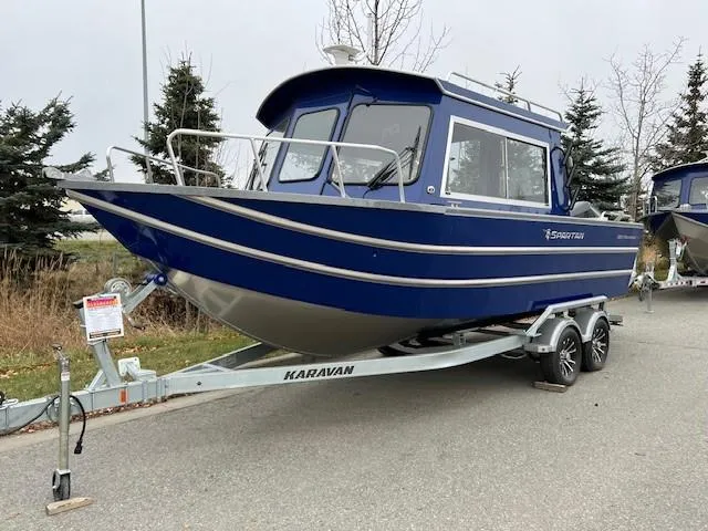 Slide: The Image of 2023 Spartan 220 Maximus Pro boat on Karavan trailer, parked outdoors. - 7
