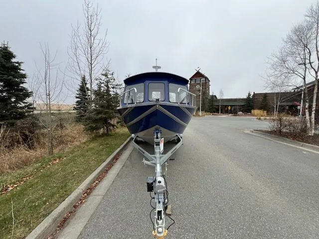 Slide: The Image of 2023 Spartan 220 Maximus Pro boat on trailer in parking lot. - 8