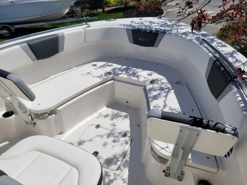Slide: The Image of 2024 Robalo R232EX boat interior with seating and storage compartments. - 10