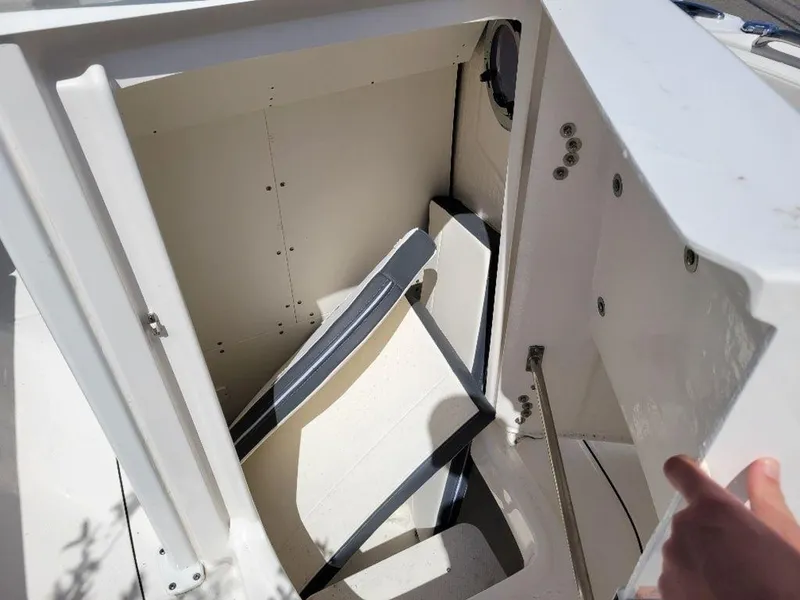 Slide: The Image of 2024 Robalo R232EX boat storage compartment with open hatch. - 11