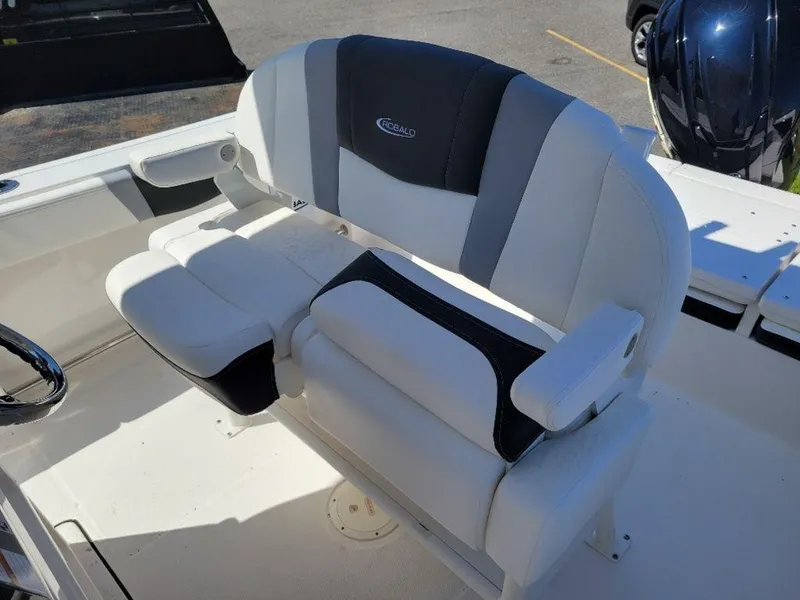 Slide: The Image of 2024 Robalo R232EX boat seating with white and gray upholstery. - 12