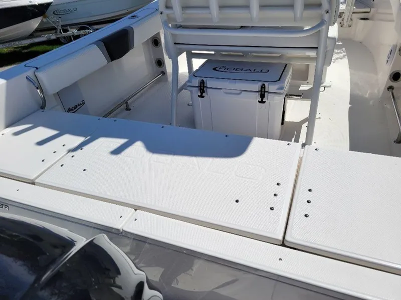 Slide: The Image of 2024 Robalo R232EX boat interior with seating and storage. - 7