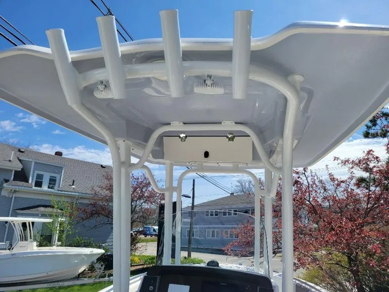 Slide: The Image of 2024 Robalo R232EX boat T-top with rod holders and electronics box. - 8