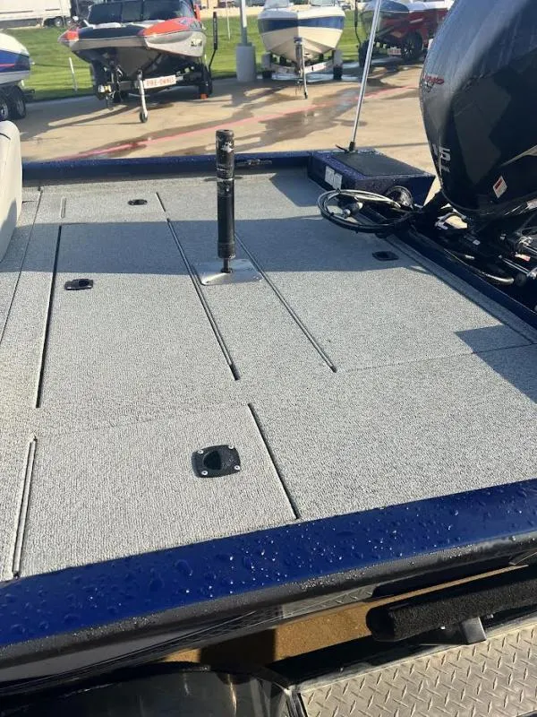 Slide: The Image of 2017 G3 Sportsman 19 boat deck with motor, parked among other boats. - 10