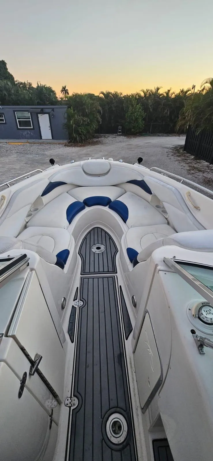 Slide: The Image of 2002 Monterey 262 Cruiser boat with white and blue seating at sunset. - 6