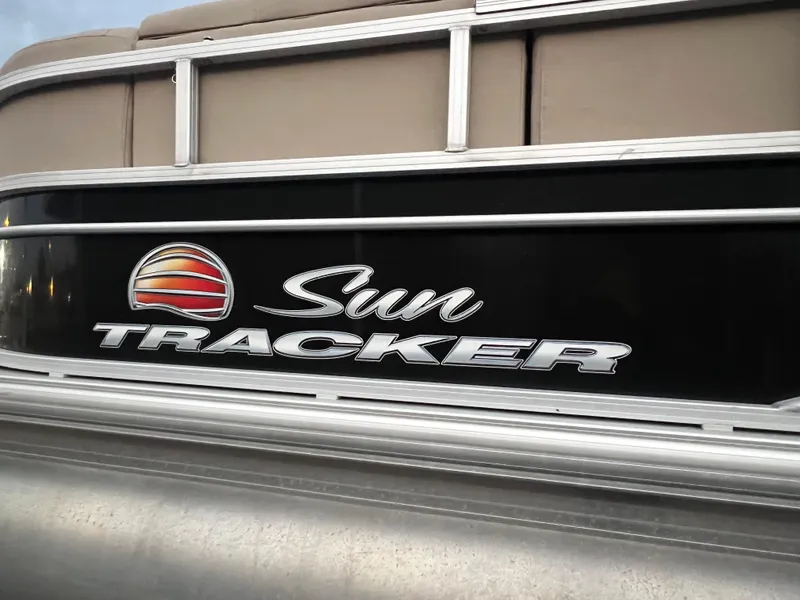 Slide: The Image of 2018 Sun Tracker Party Barge 22 DLX logo on boat exterior. - 13