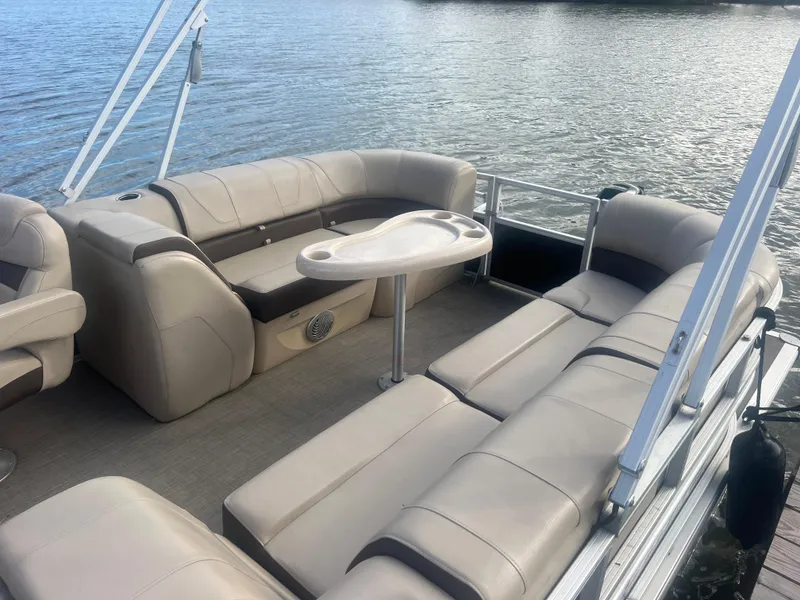 Slide: The Image of 2018 Sun Tracker Party Barge 22 DLX pontoon boat with spacious seating and table on the water. - 16