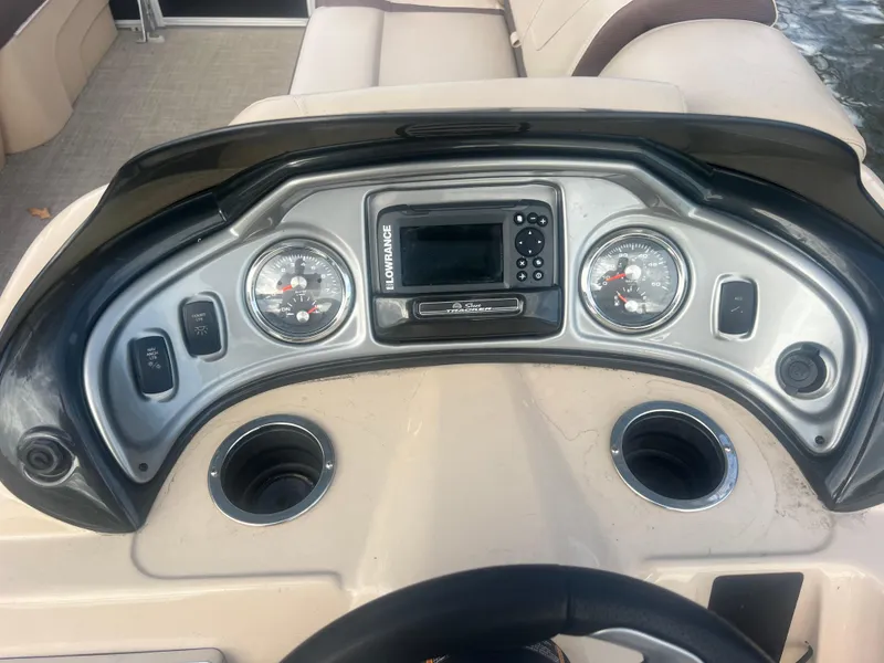 Slide: The Image of 2018 Sun Tracker Party Barge 22 DLX dashboard with gauges and Lowrance display. - 22