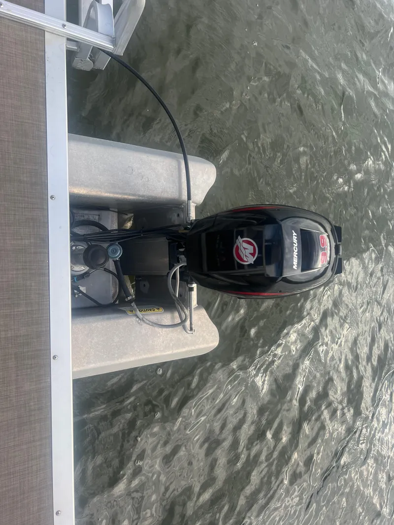 Slide: The Image of 2018 Sun Tracker Party Barge 22 DLX with Mercury outboard motor on water. - 23