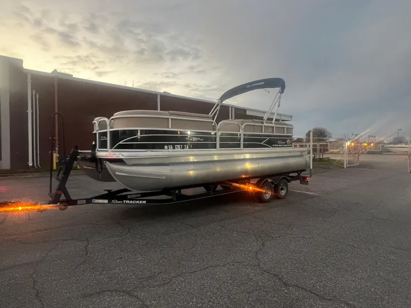 Slide: The Image of 2018 Sun Tracker Party Barge 22 DLX pontoon boat on trailer at dusk. - 3