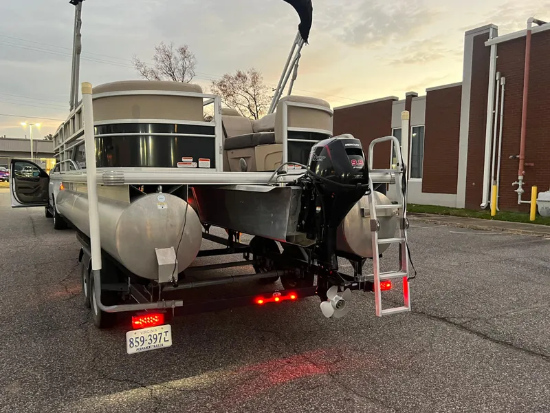 Slide: The Image of 2018 Sun Tracker Party Barge 22 DLX pontoon boat on trailer at sunset. - 5