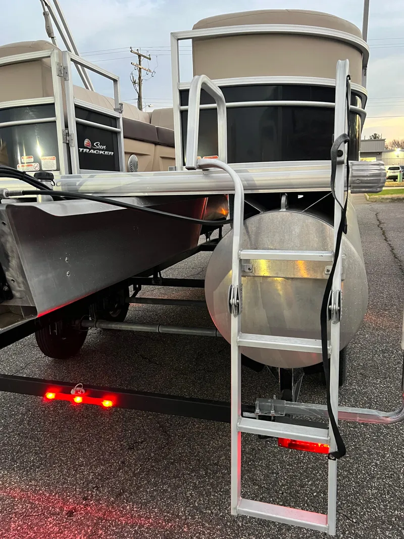Slide: The Image of 2018 Sun Tracker Party Barge 22 DLX rear view with boarding ladder. - 8