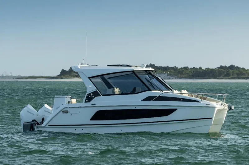 Slide: The Image of 2024 Aquila 36 Sport boat cruising on open water. - 0